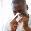 Man sneezing --- Image by © IAN HOOTON/Science Photo Library/Corbis